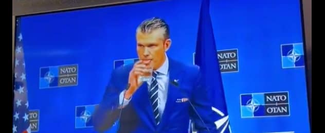 Pete Hegseth Drinking at Podium